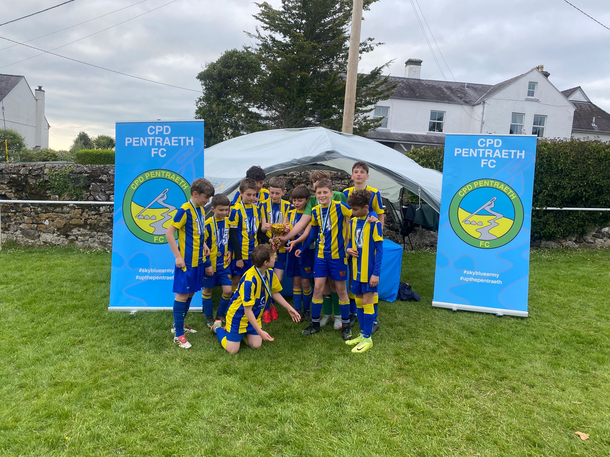 Phoenix junior players celebrating with a trophy