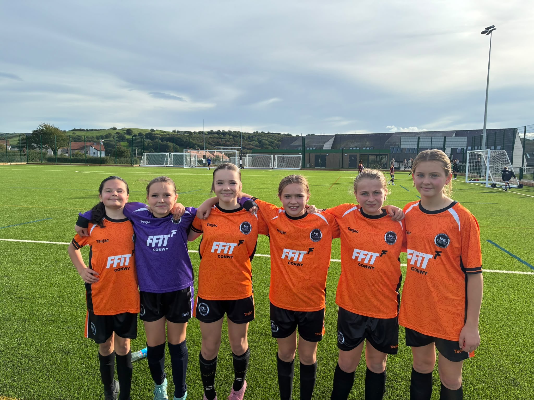 Boe Blackall, Nancy Tharme, Mali Evans, Elin Edwards, Nel Jones-Hughes and Emmi Williams in county football kit