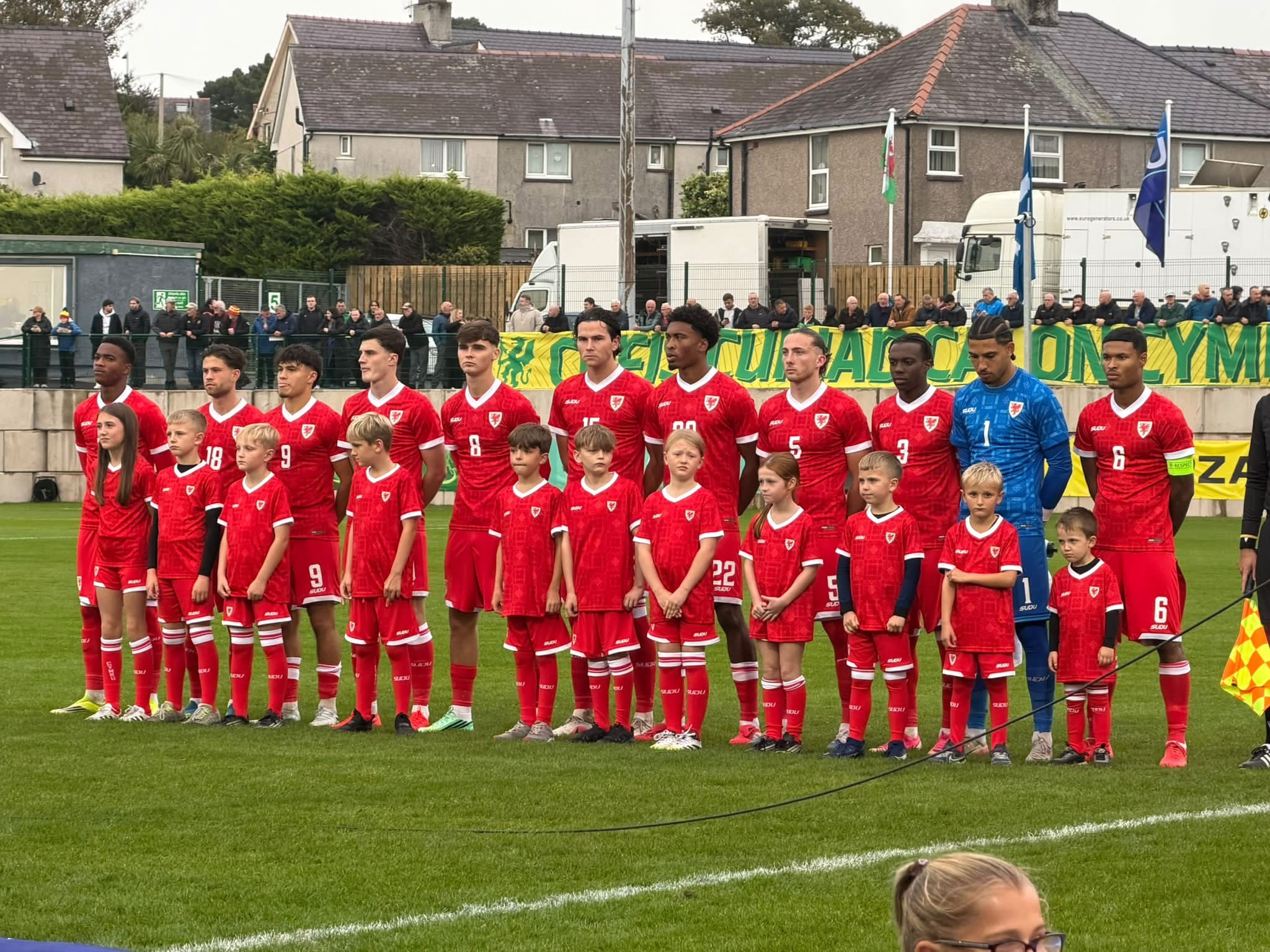 Wales U21 players and mascots standing together before the match