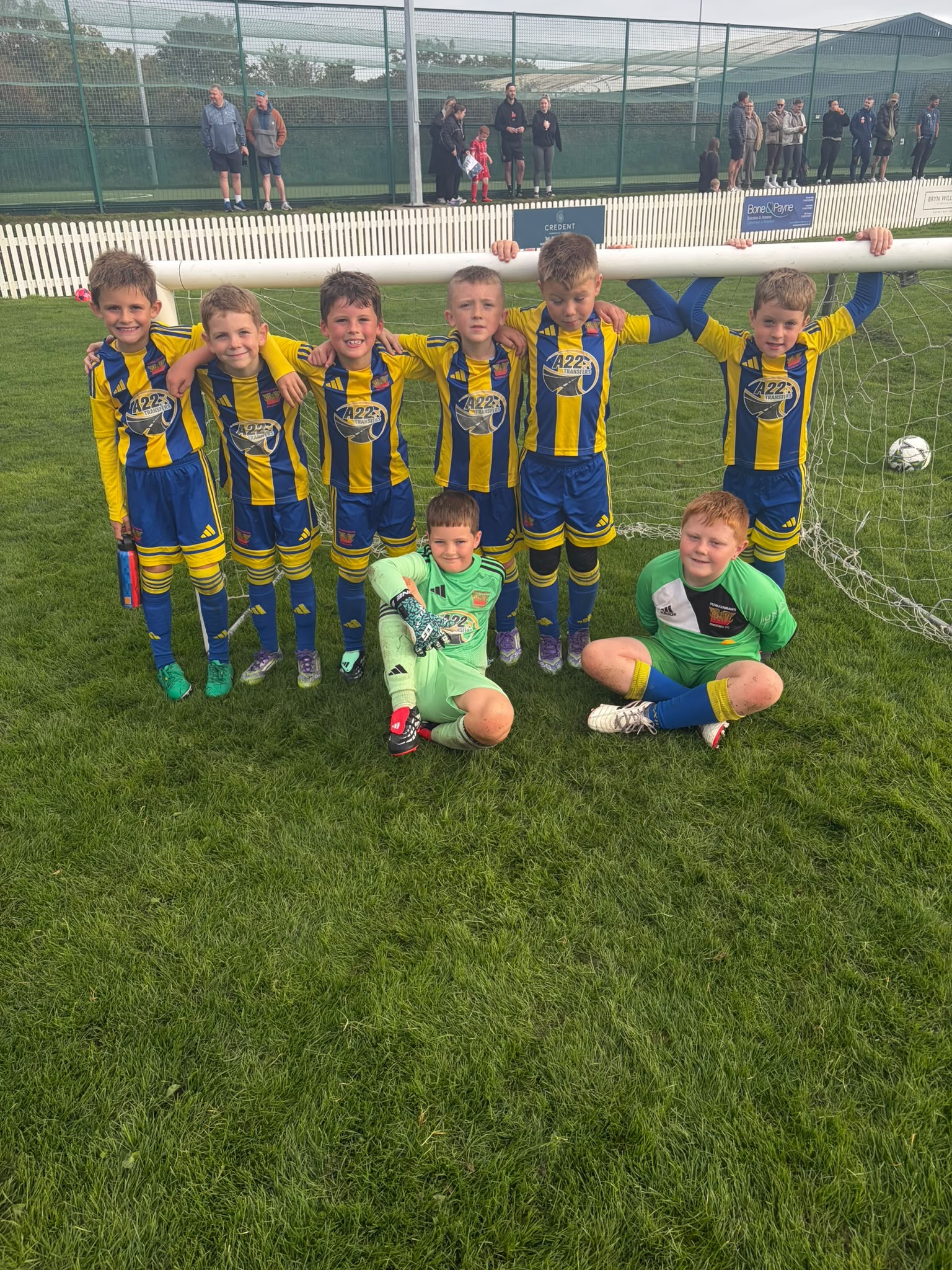 Phoenix U9 boys gathered in front of a goal after their game at Mochdre