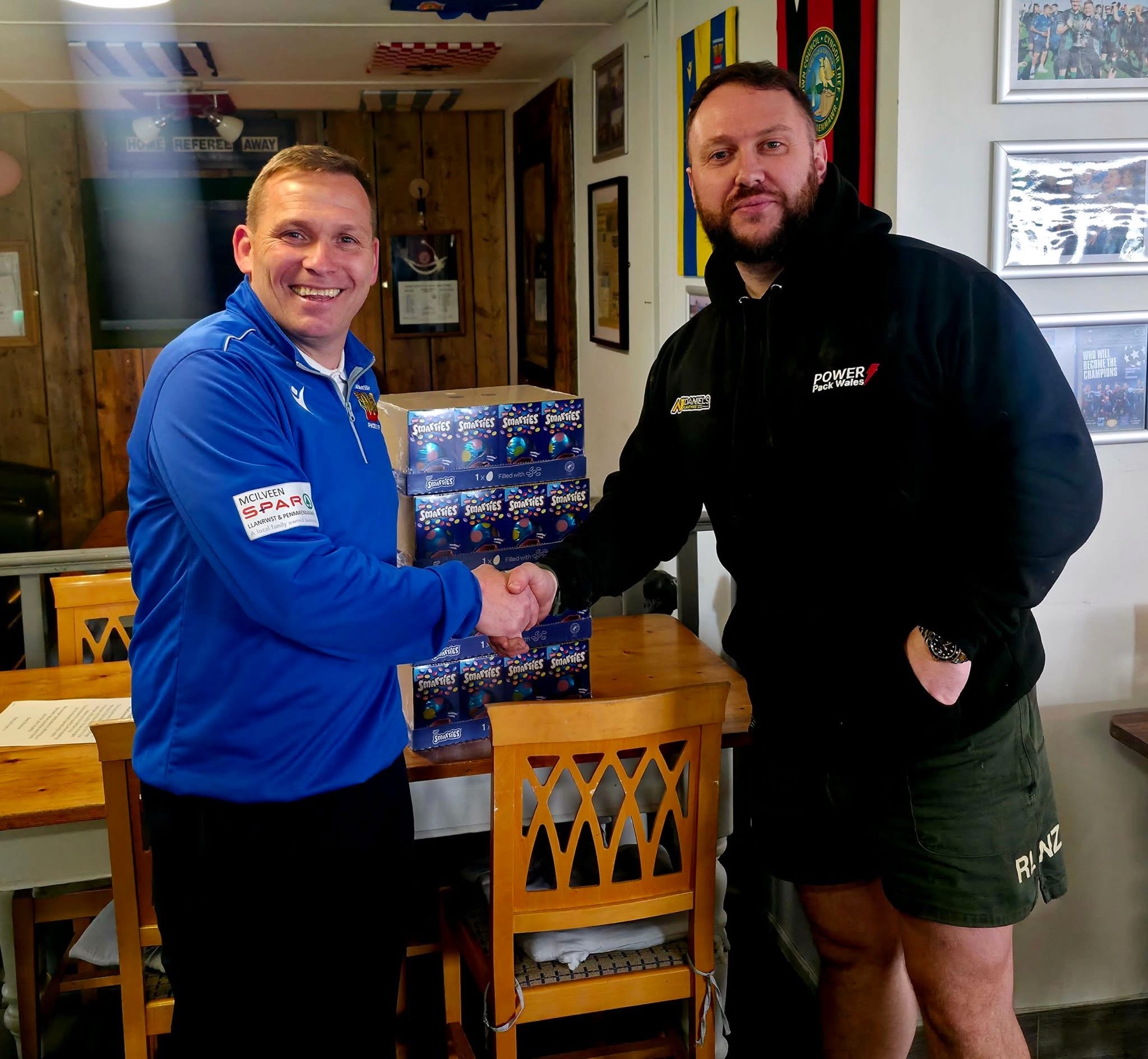 Ashley Daniels presenting Easter eggs donation to Pete Williams